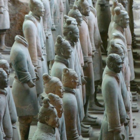 A rank of soldiers. One of the soldiers on the left is missing his head, a result of the statues being made in pieces and then assembled.