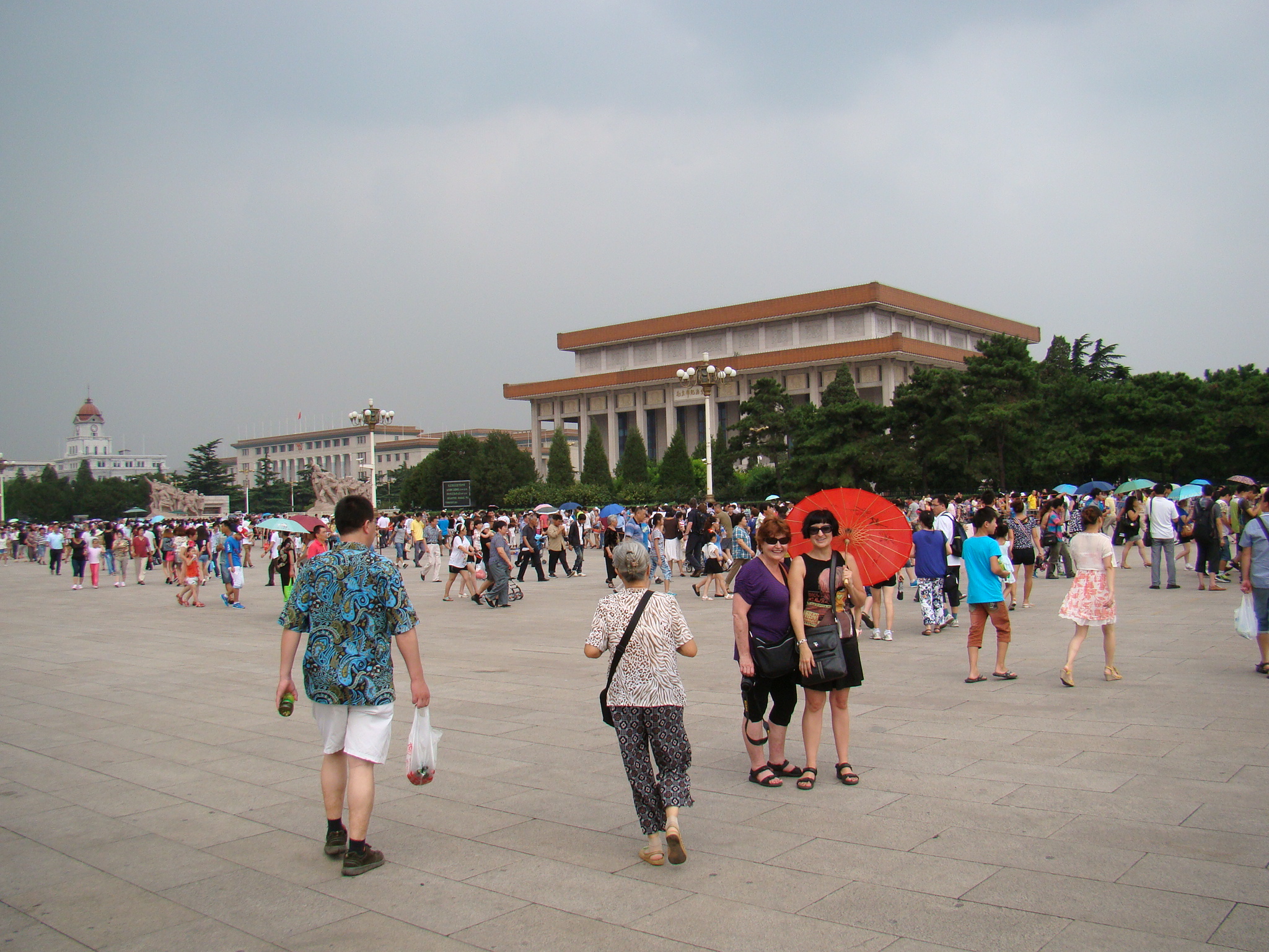 Me and mom stansing on Tiananmen Square with the mausoleum behind us.